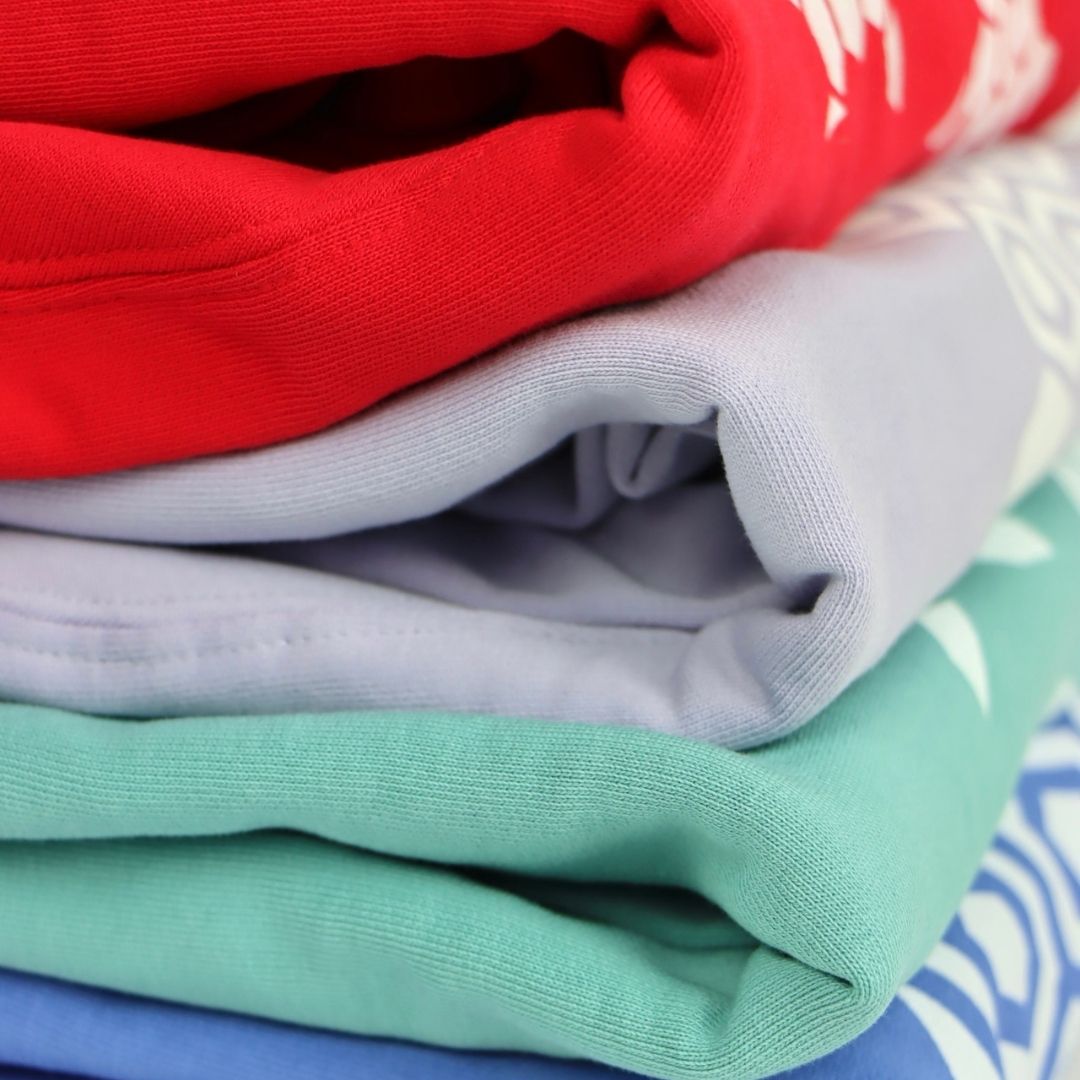 organic hoodies in red, lavender, teal and bright blue, folded, showing quality finish